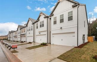 a row of white houses on the side of a street