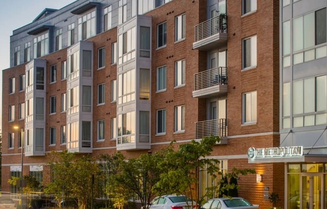 an apartment building on a city street at dusk