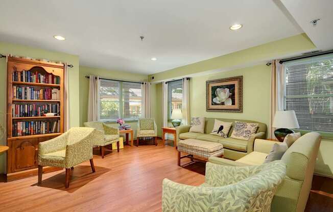 a living room filled with furniture and a book shelf
