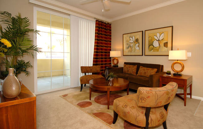 Livingroom with couch, coffeetable, chairs and large windows