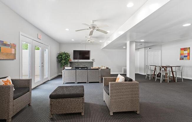 Clubhouse with chairs and tv at Barracks West apartments in Charlottesville, VA