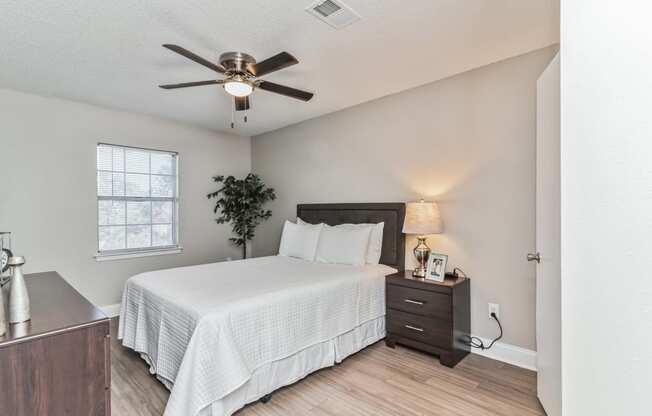 a bedroom with a large bed and a ceiling fan