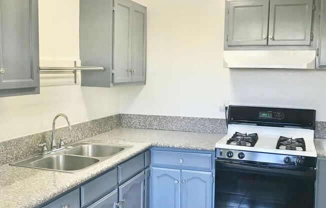 Downstairs 2 Bedroom Apartment Unit With Stove and Refrigerator Included!