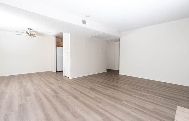 A room with a ceiling fan and light fixture.