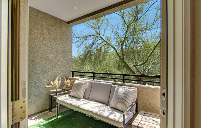 a balcony with a couch and a table