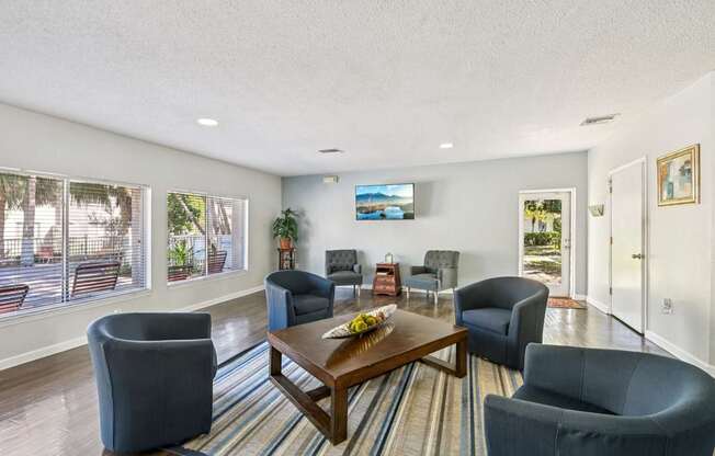 A living room with a large couch, a chair, and a coffee table.