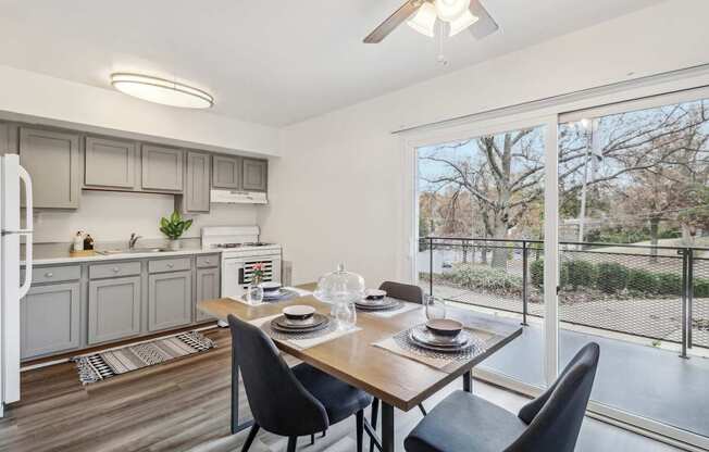 a living room with a large window and a table with chairs