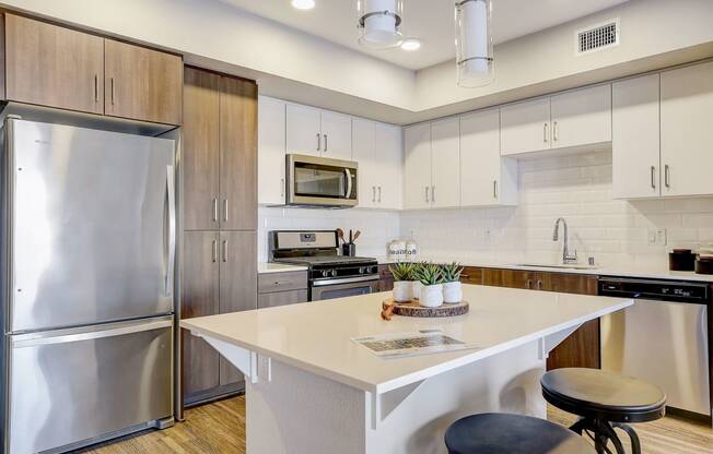 a kitchen with stainless steel appliances and a white counter top