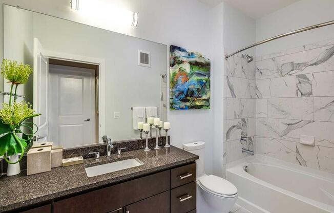 a bathroom with a sink and a toilet and a shower