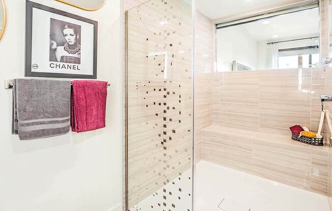 A bathroom with a Chanel towel hanging on the wall.