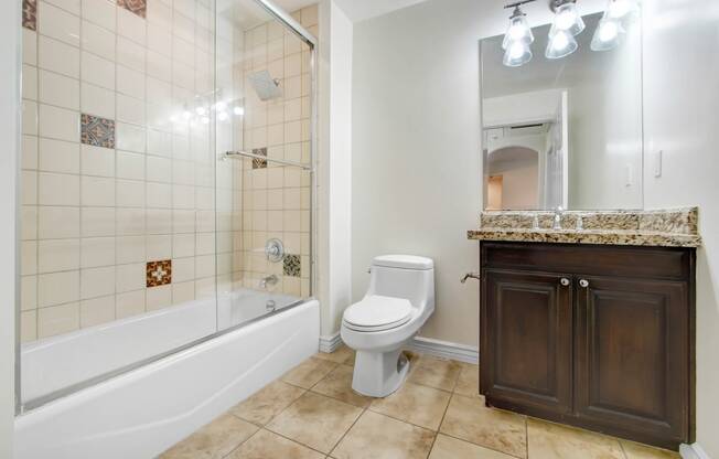 a bathroom with a toilet and a tub and a sink