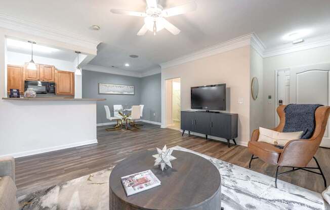 A living room with a grey sofa and a wooden coffee table.