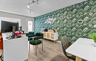 A room with a white desk and a green chair.