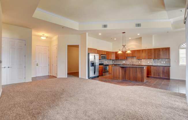 A spacious kitchen with wooden cabinets and a refrigerator.