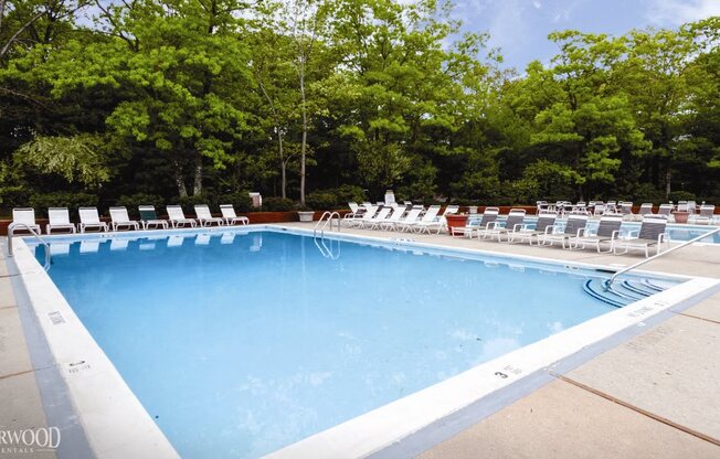 outdoor adult pool with clear blue water at Town & Country Luxury Apartments, Hampton Bays, NY, 11946