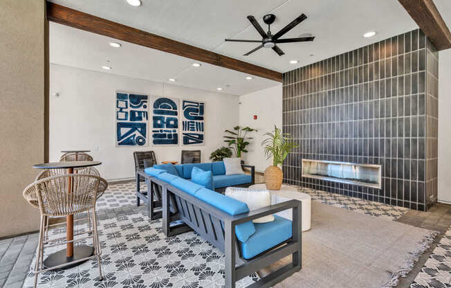 A living room with a blue couch and a black and white tiled floor.