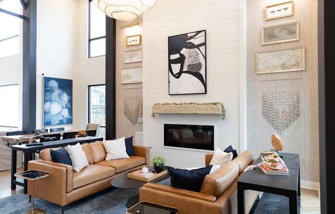 A living room with a fireplace and a painting above it.