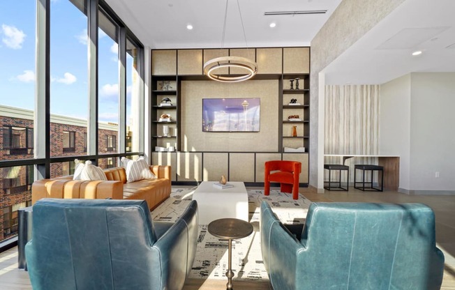 a living room with blue furniture and large windows