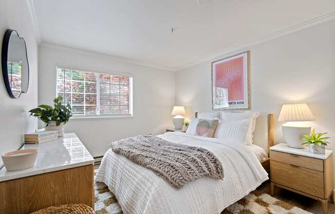 a bedroom with a bed and a dresser and a window