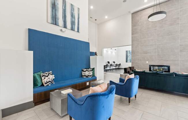 A blue sofa and chair in a room with a fireplace.