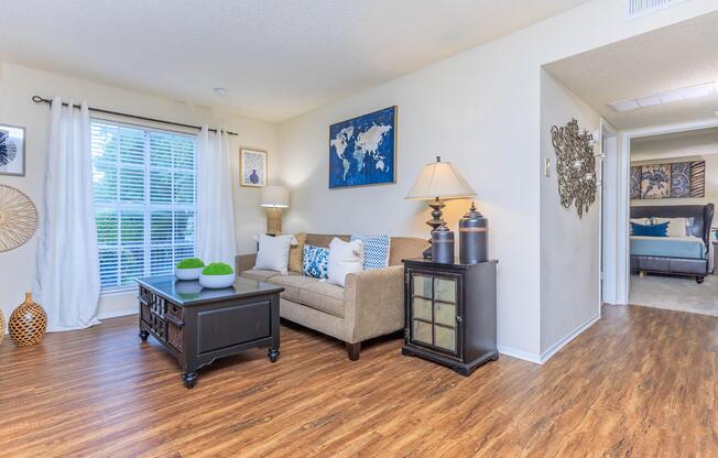 a living room filled with furniture on top of a hard wood floor
