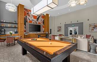 a clubhouse with a pool table and a tv