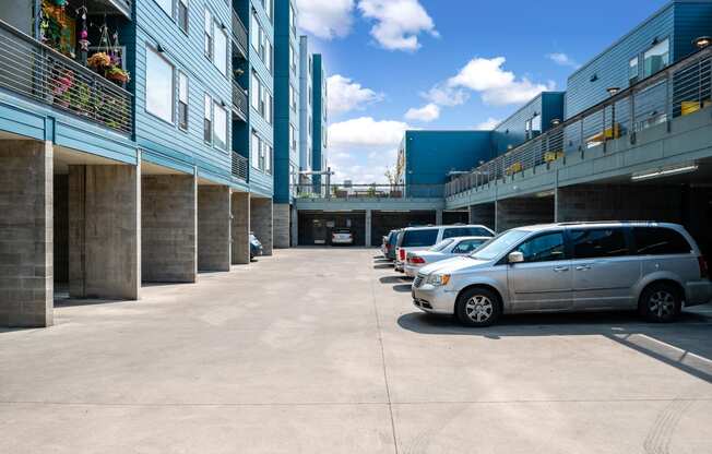 a row of parked cars in front of a building