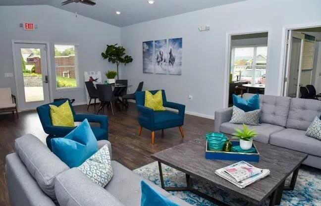 a living room with couches and chairs and a table