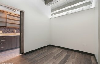 an empty room with a sink and a mirror