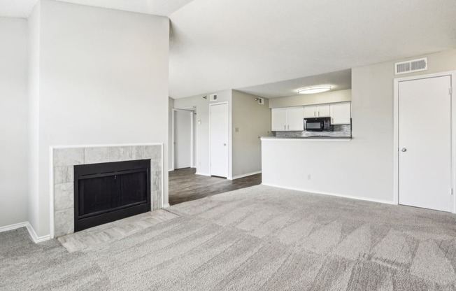 A3 floor plan living room with a fireplace and a kitchen at Jefferson Creek Apartments in Irving, TX.