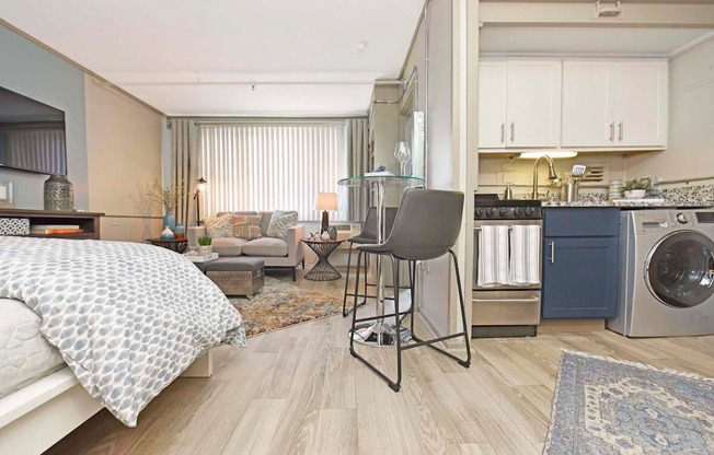 combo washer and dryer in kitchen and wood-style floors throughout