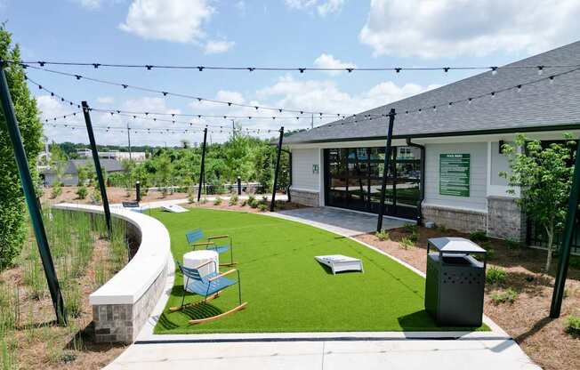 A playground area with a slide and a green lawn.