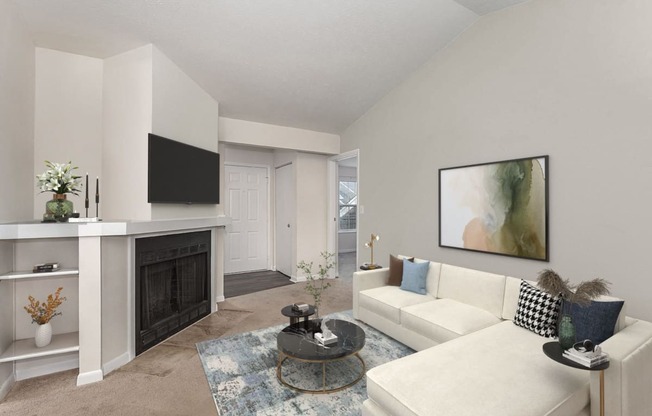 a living room with a white couch and a fireplace