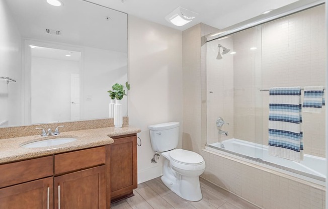 a bathroom with a shower toilet and sink