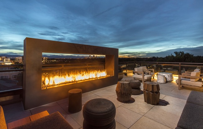 Experience the ultimate cozy retreat with our outdoor rooftop fireplace