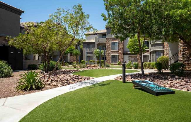 A grassy area in front of apartment buildings.