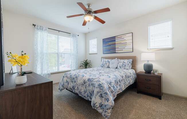 a bedroom with a bed and a ceiling fan