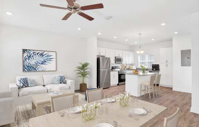 a living room with a dining room table and a kitchen