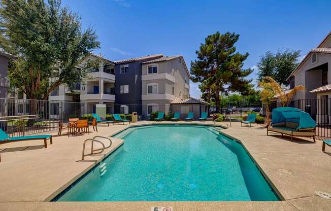 our apartments have a large swimming pool with chairs and umbrellas