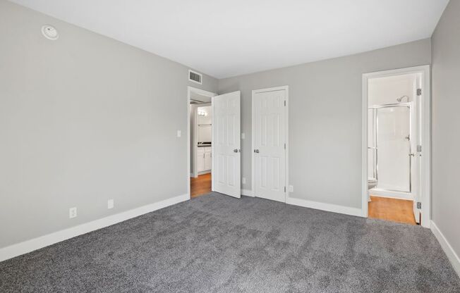 wall to wall carpet, stylish decor, and white walls at The Reserve at Warner Center, California