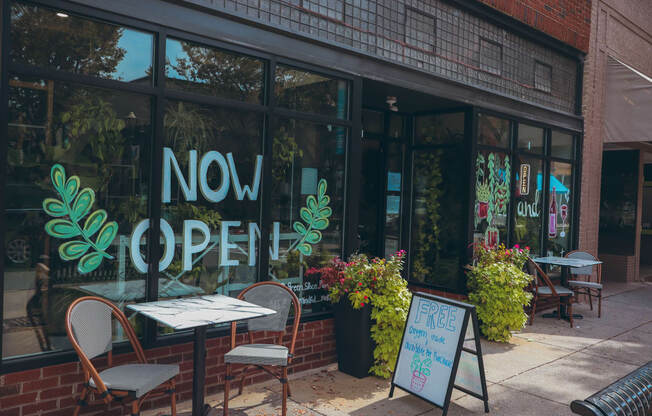 a restaurant with a now open sign in the window