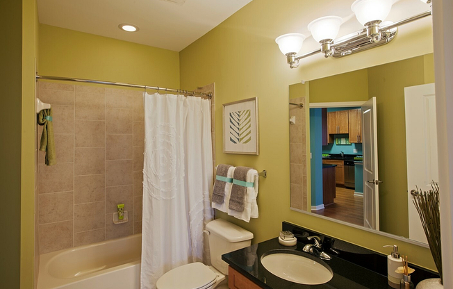 Large Bathroom With Tiled Shower, Granite Vanity Counter, Ample Storage Space & Modern Lighting