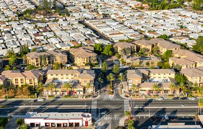 A large aerial view of a residential area with houses and a shopping center.