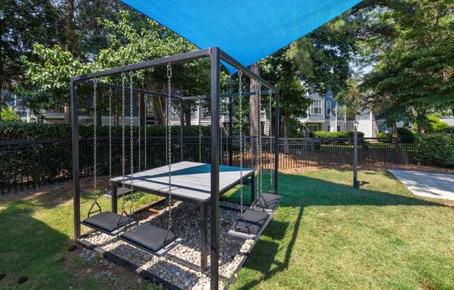 a playground with a swing set and a ping pong table