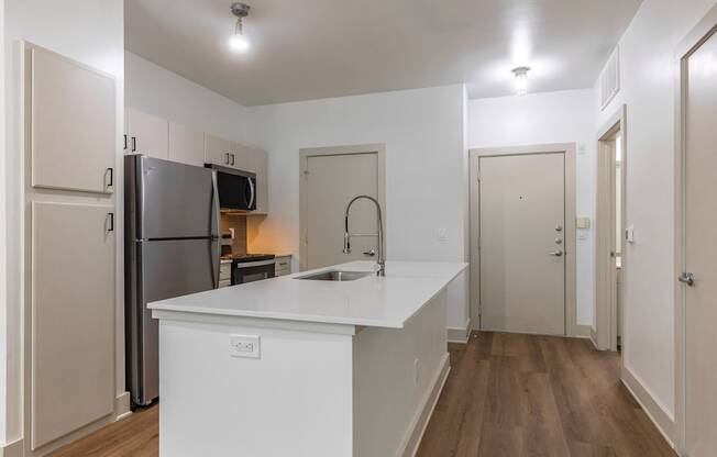 A kitchen with a white countertop and a refrigerator.
