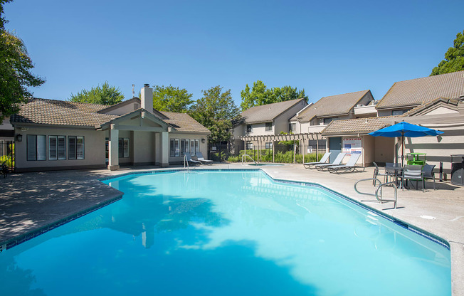 A swimming pool and clubhouse at Zinfandel Village Apartments, California, 95670