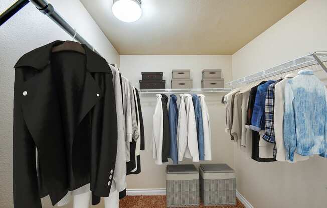 a wardrobe with clothes hanging on a rack in a closet