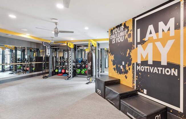 A gym with a sign that says "I am my motivation".