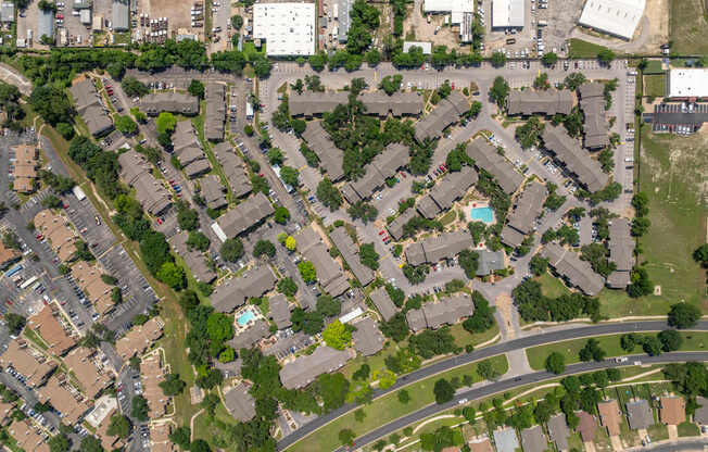 A bird's eye view of a residential area with houses and roads.