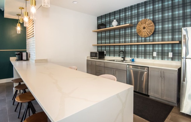 a kitchen with a white counter top and stainless steel appliances